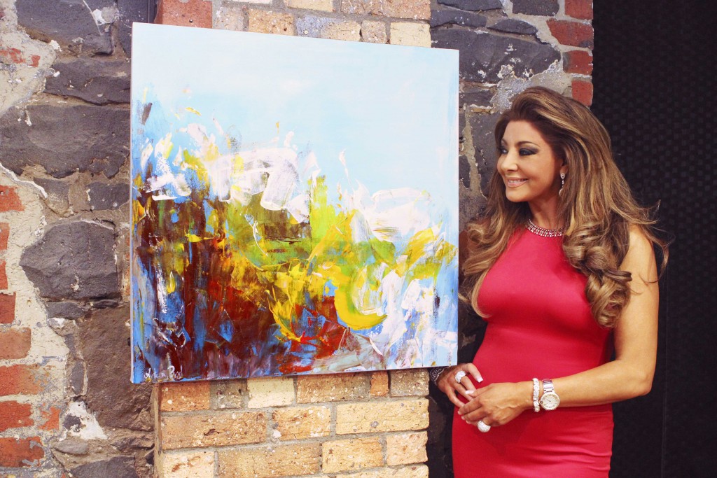Gina Liano with her new painting by Artem Bryl
