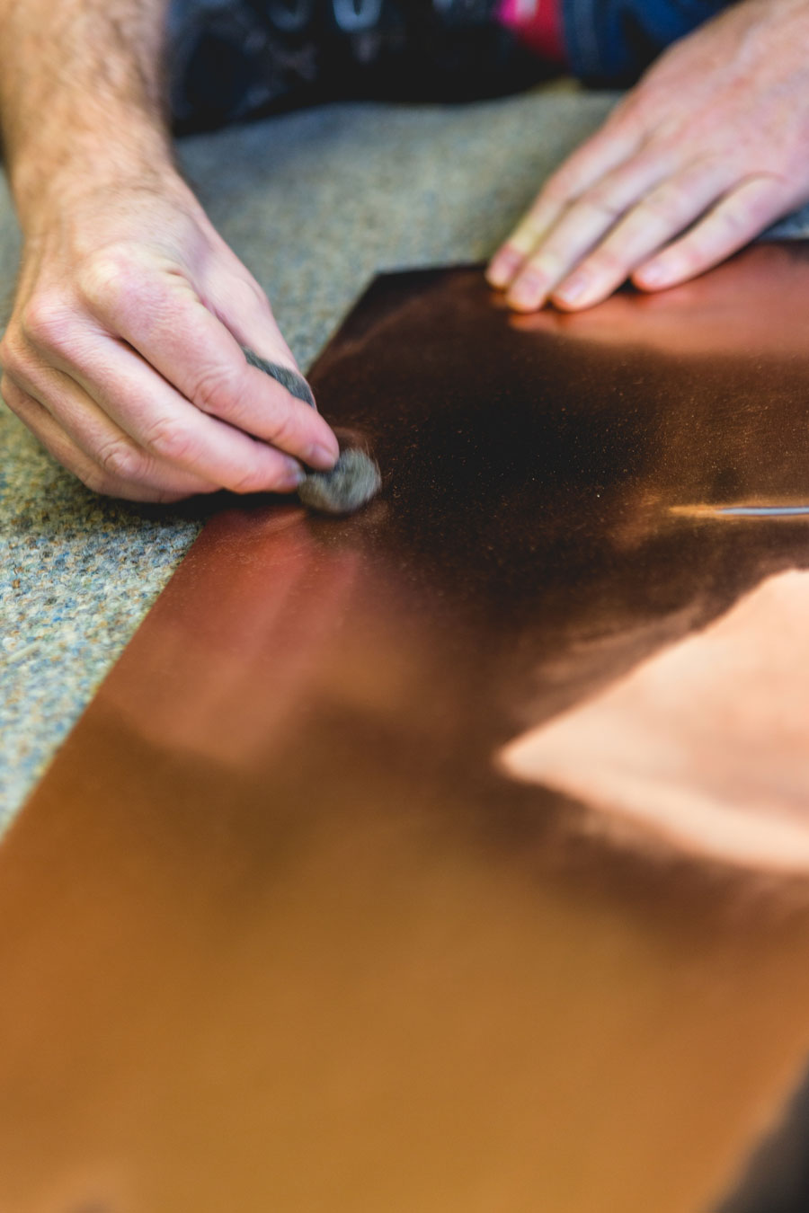 Artist polishing copper