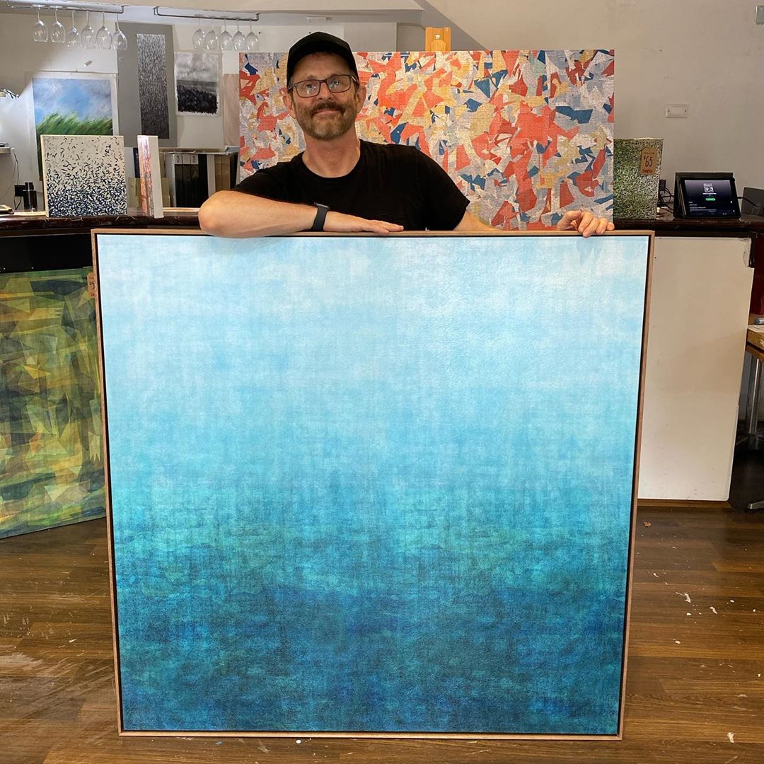 Local Sydney artist George Hall with his blue abstract artwork