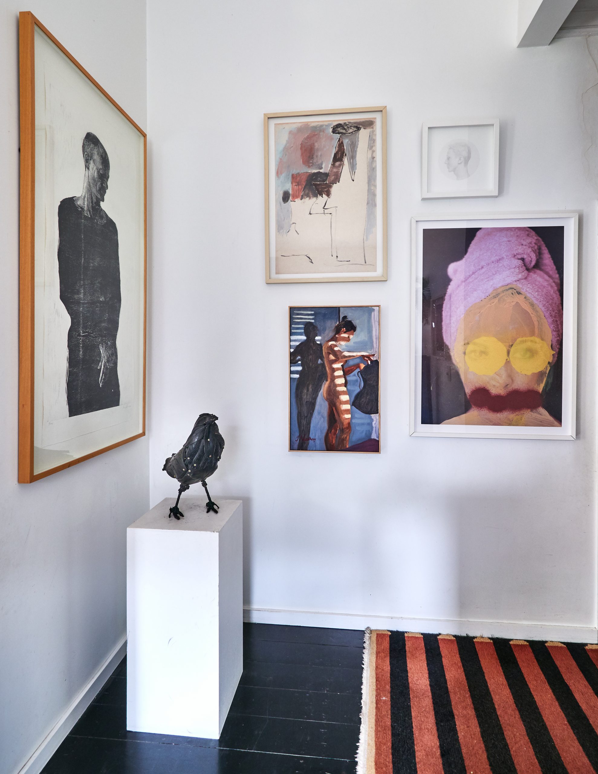 gallery wall display with bird sculpture