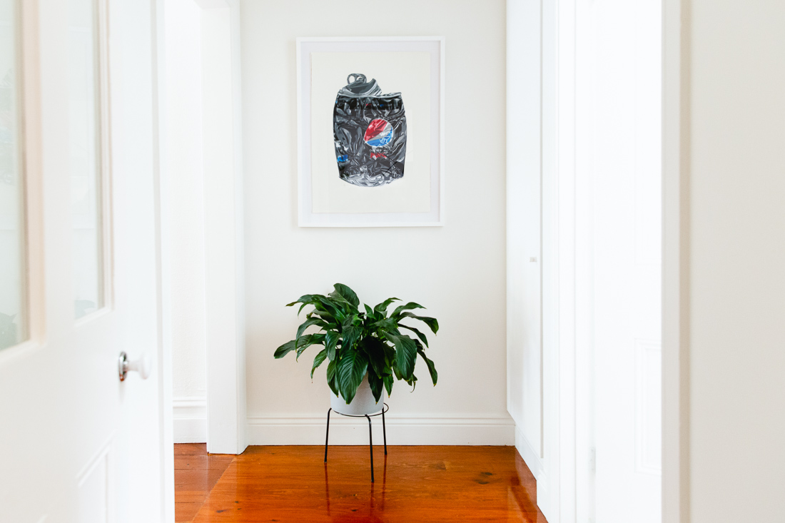 Logan Moody's crushed Pepsi Max can print hangs in the hallway