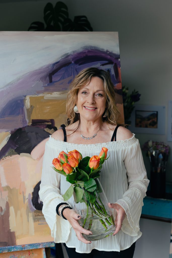 Artist Jen Shewring holding orange tulips