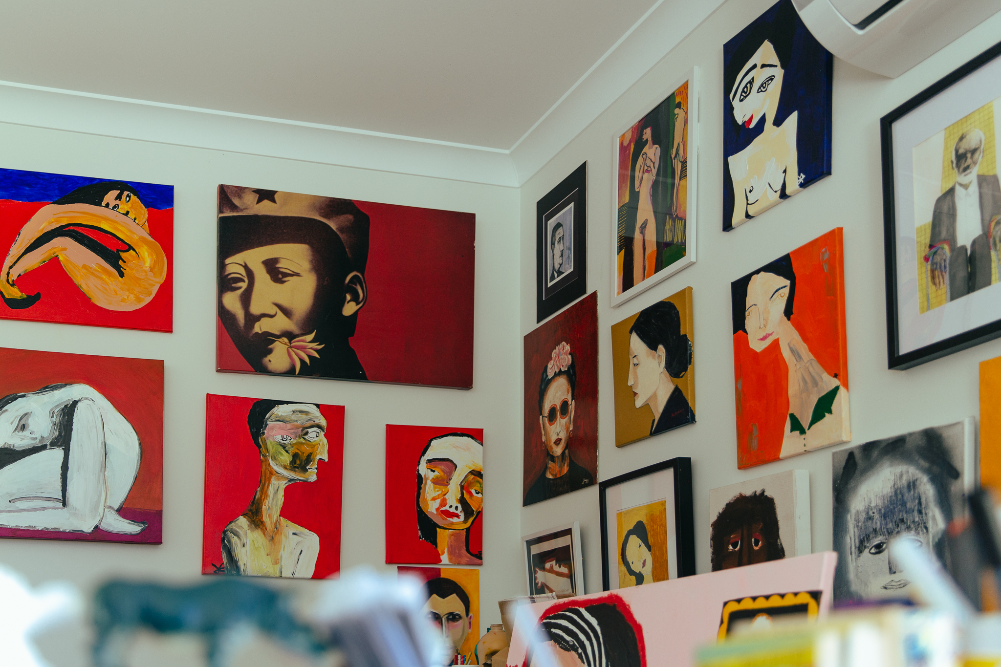 gallery wall hang of brightly coloured portraits