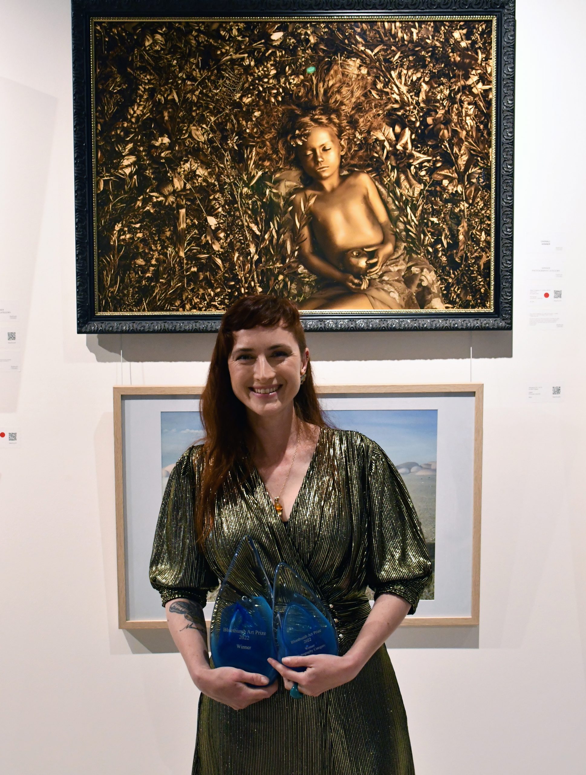 Bluethumb Art Prize 2022 overall winner Lauren Starr in front of her winning work, Midas' Daughter II.