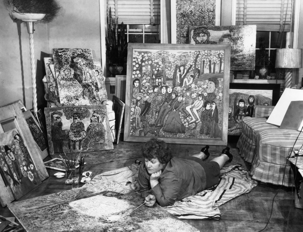 Janet Sobel is pictured laying on the floor of her studio. 