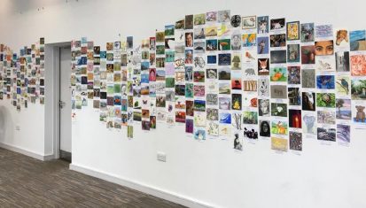 A wall of postcards