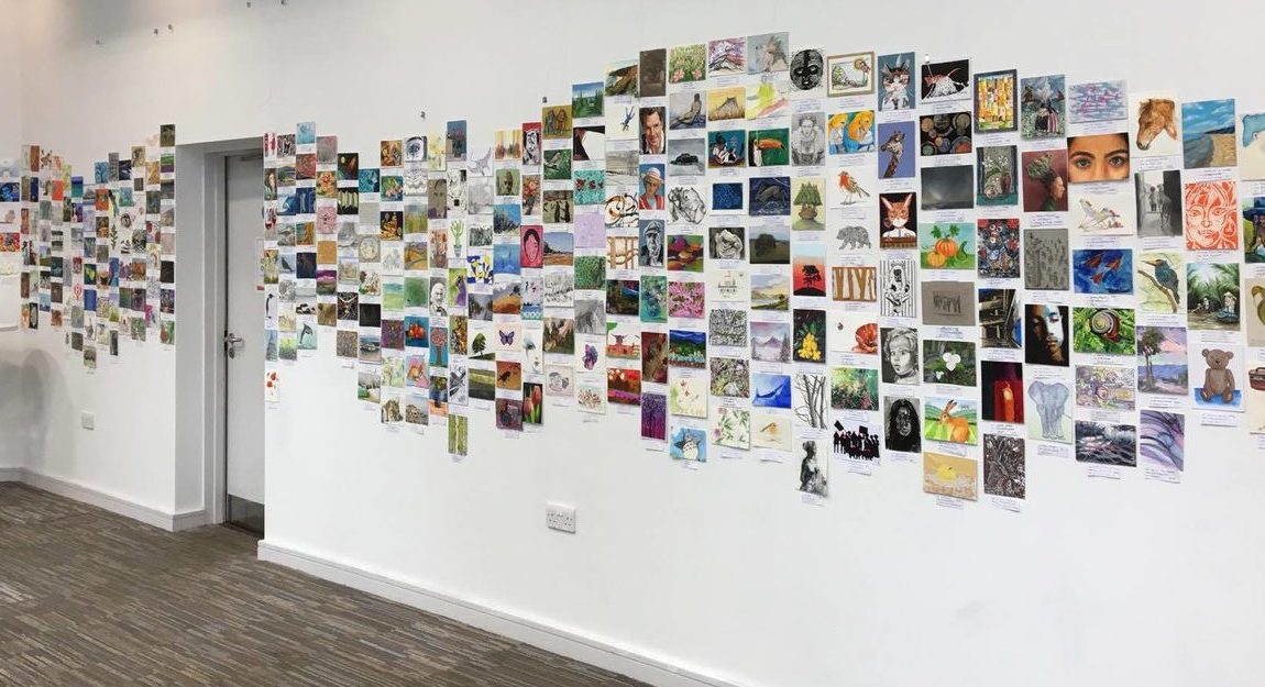 A wall of postcards