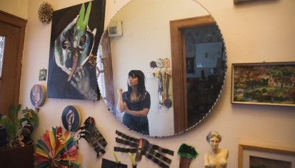 artist reflected in hallway mirror