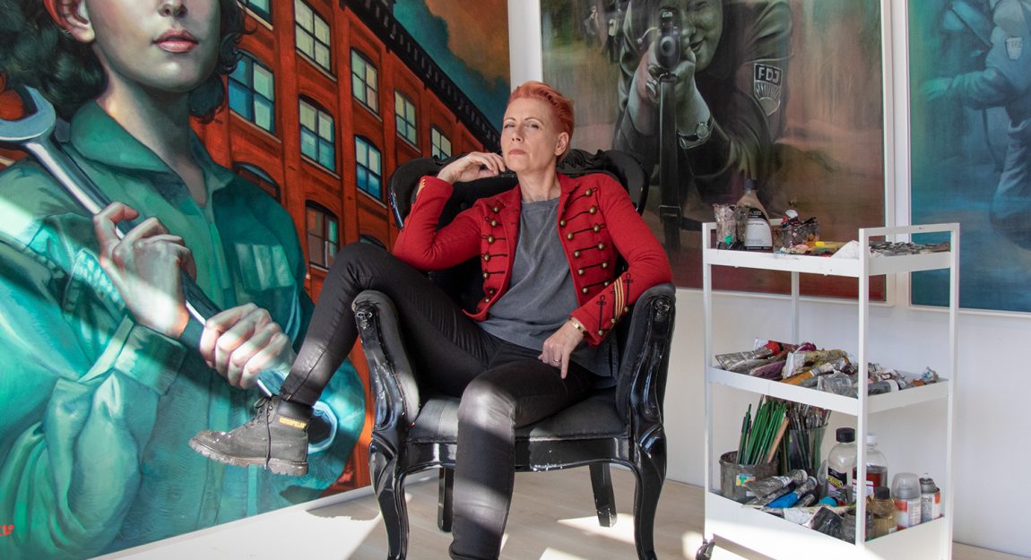 artist Kathrin Longhurst sitting in front of her artworks.