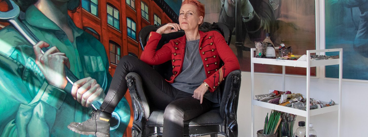 artist Kathrin Longhurst sitting in front of her artworks.